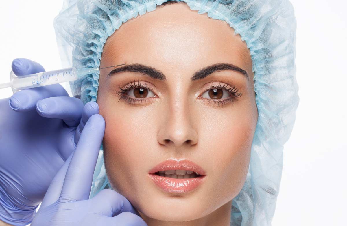 Woman receiving safe Botox injection by qualified practitioner wearing gloves at Cosmetic Surgery Partners UK