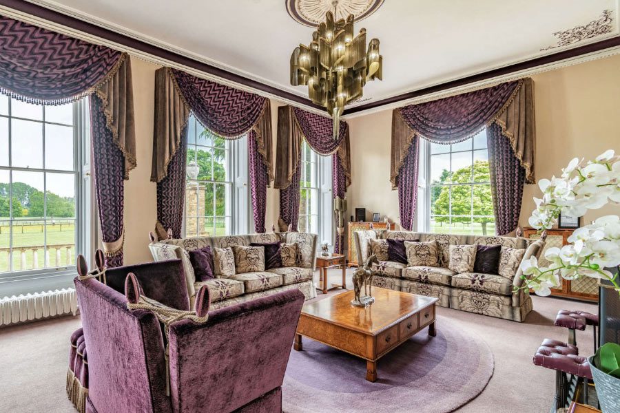 Waiting Room: The luxurious patient waiting room at Cosmetic Surgery Partners, Hemingford Park Hall, featuring purple velvet furnishings and ornate period details